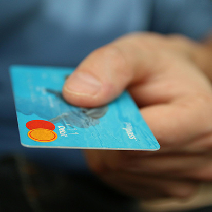 credit card in hand. Photo by Pixabay